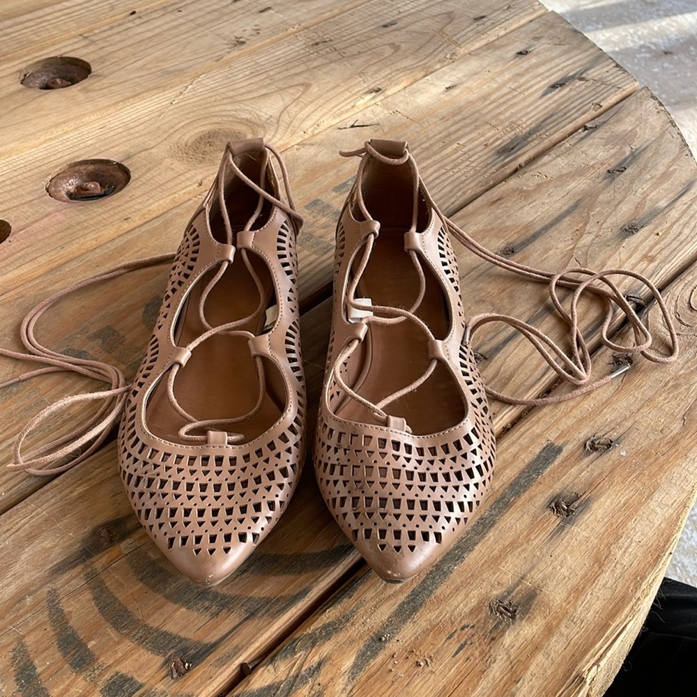 Nude colored flats that lace up